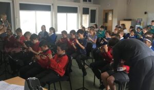 children from different schools all playing the recorder together